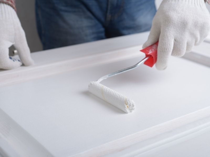 painting a door panel with a roller